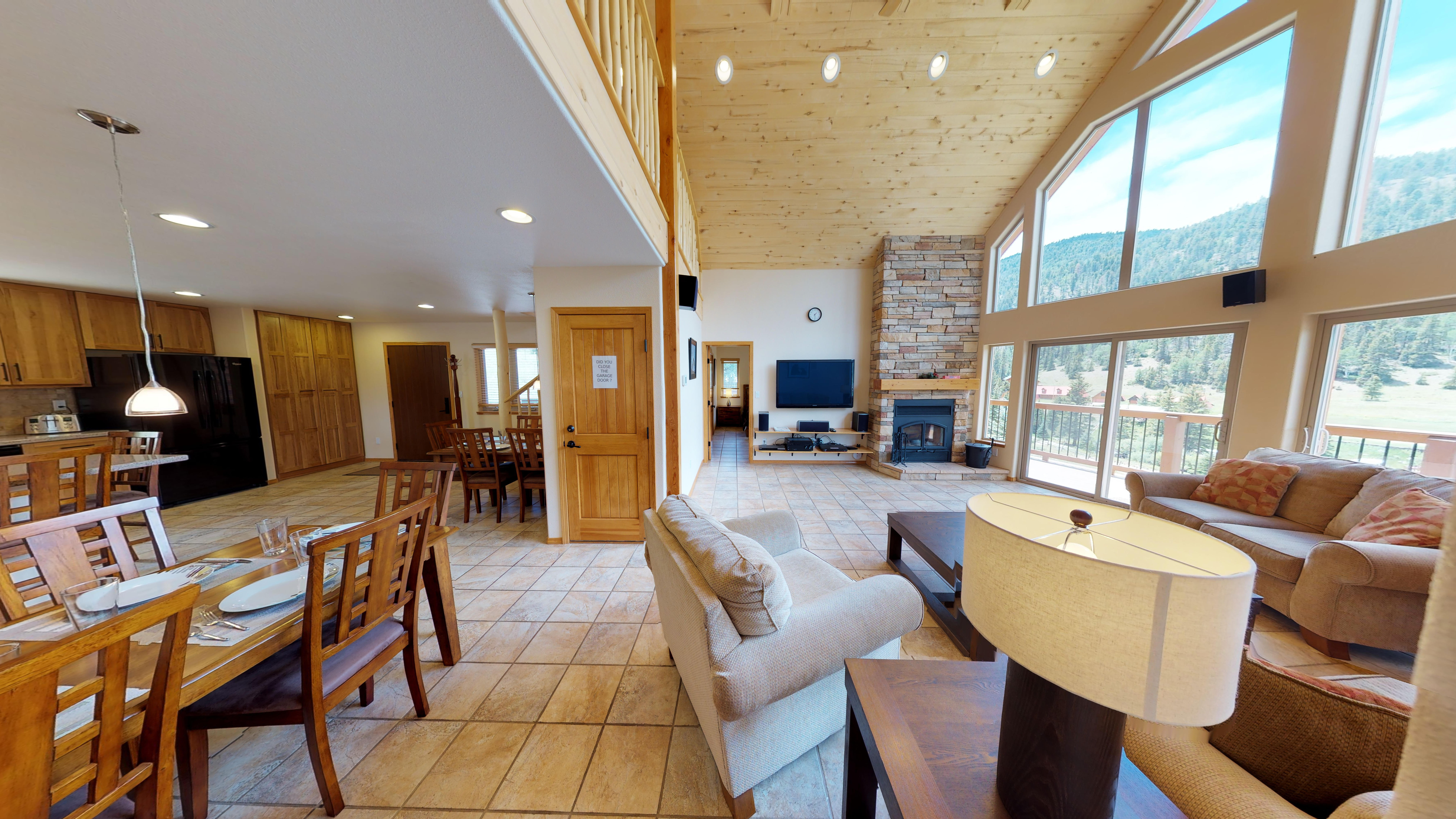 Interior of the property, including the dining room, living room, entertainment center, and fireplace.