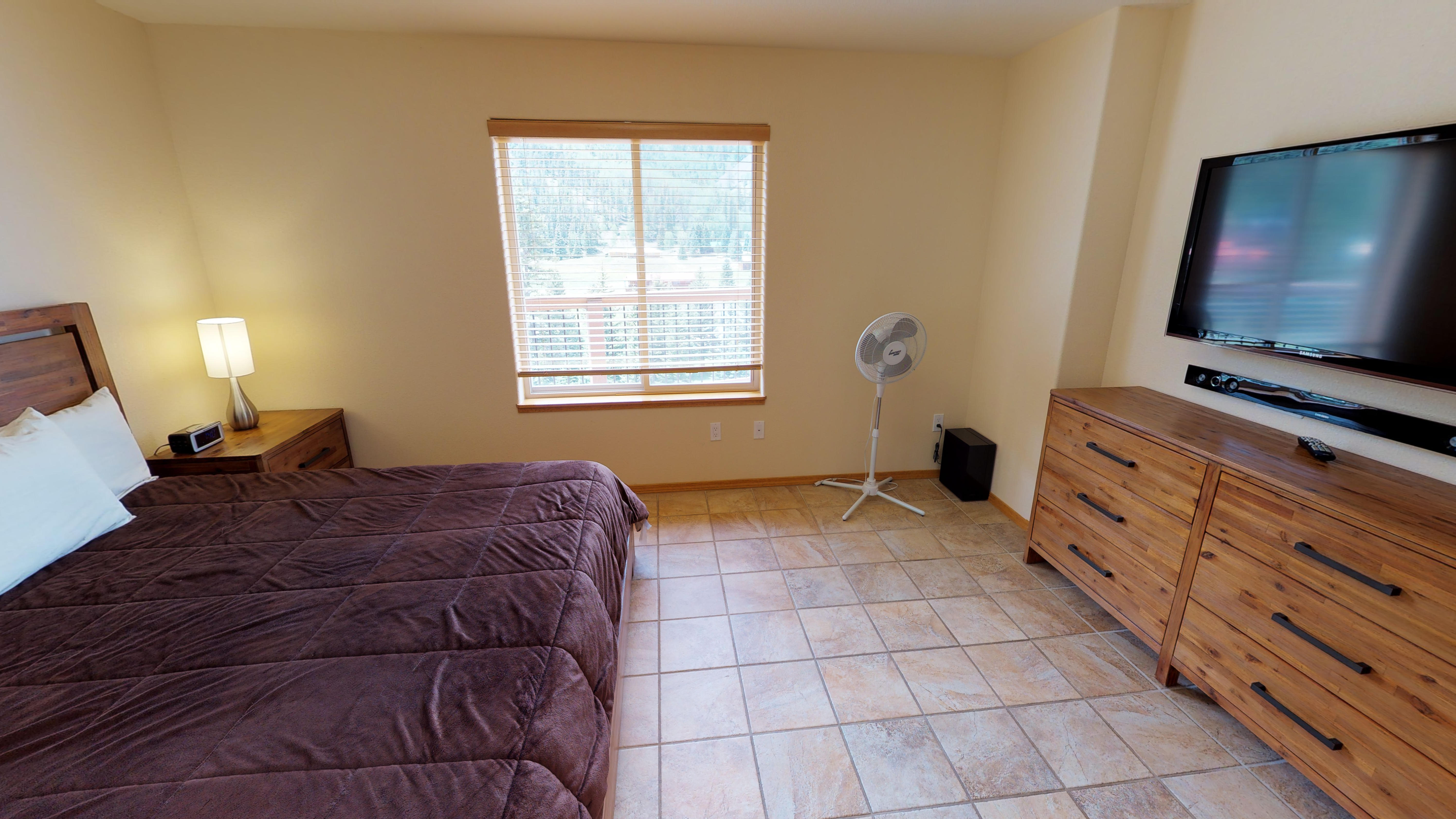 King-size bed and entertainment system in master bedroom