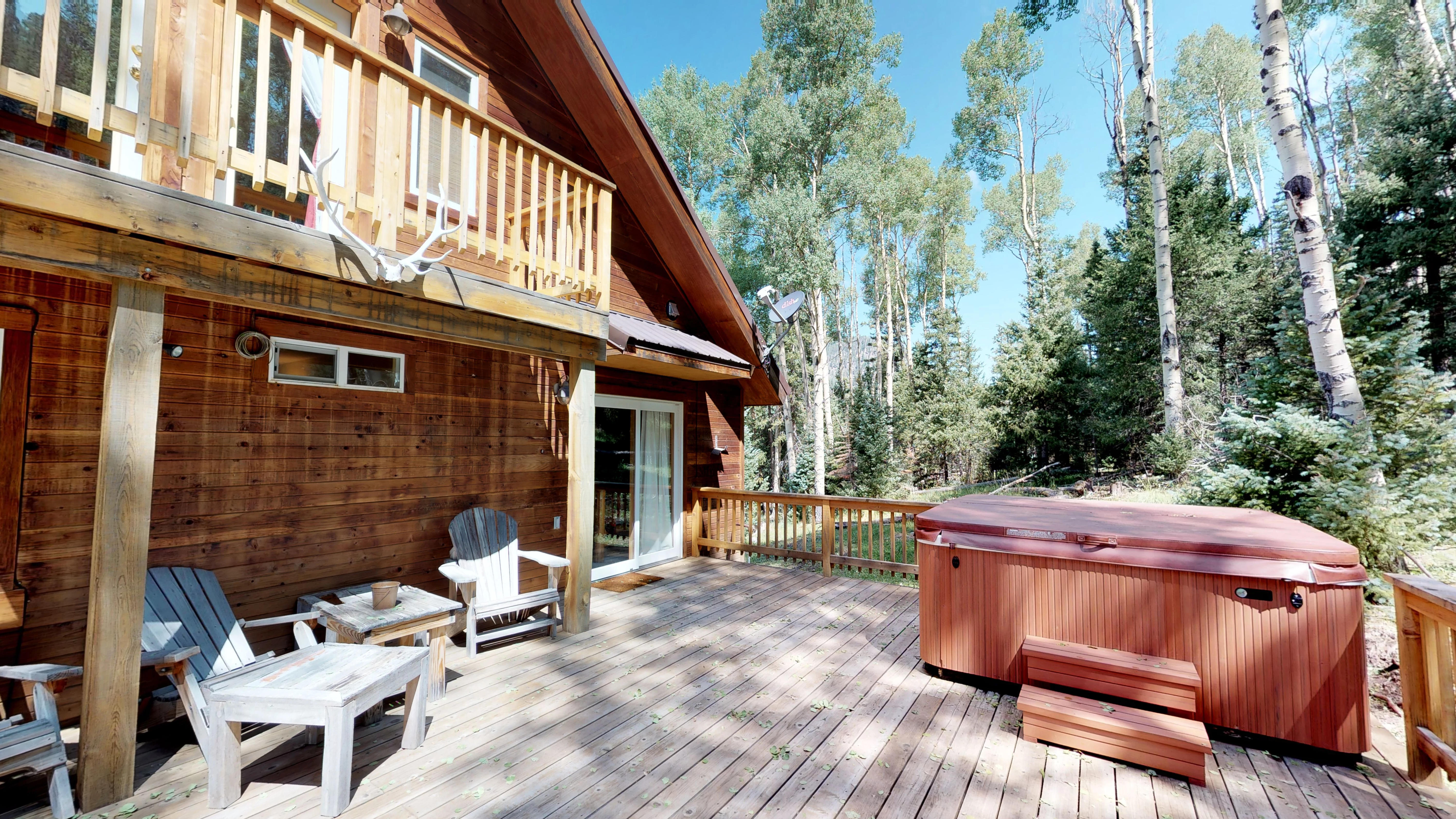 Private hot tub and seating area looking out over the backyard