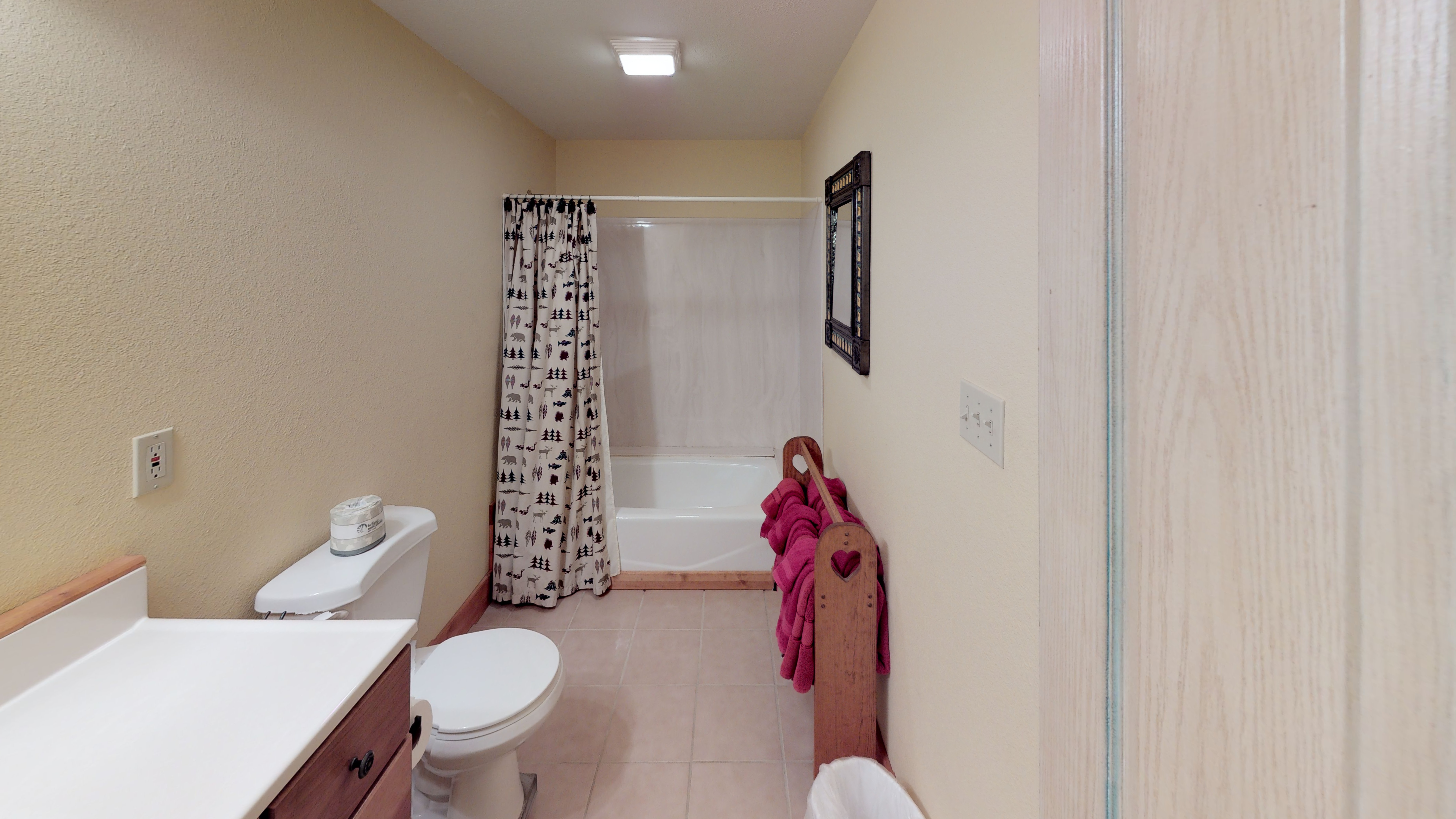 Clean bathroom fully stocked with soft towels