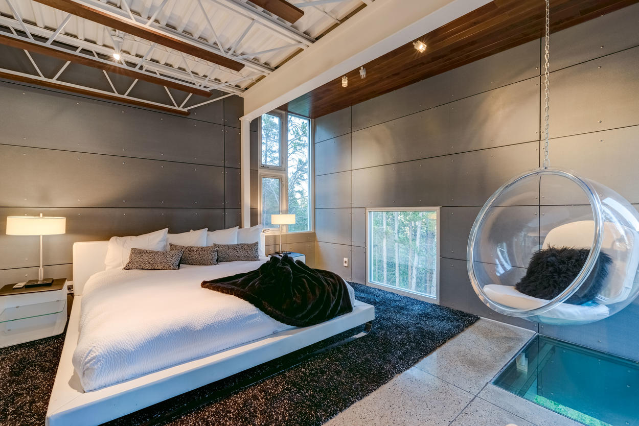 Don't miss out on experiencing the Master Bedroom's floating chair, which hangs over a glass floor that lets you peer down 30 feet to the ground below.